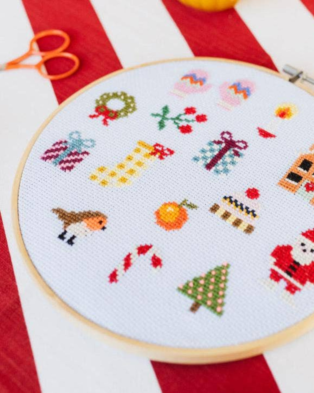 Cotton Clara Christmas-themed cross-stitch kit featuring festive colors and holiday design.