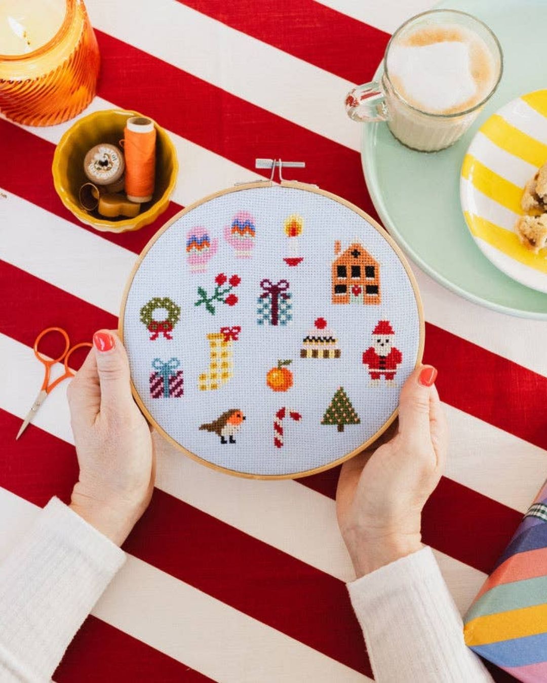 Cotton Clara Christmas-themed cross-stitch kit featuring festive colors and holiday design.