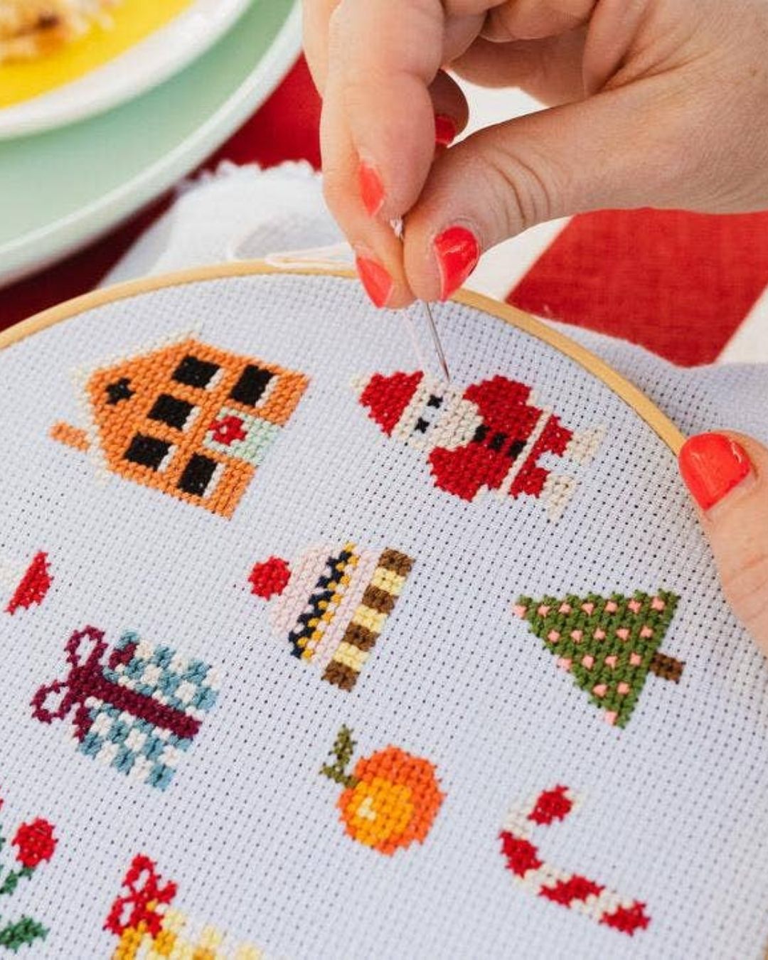 Cotton Clara Christmas-themed cross-stitch kit featuring festive colors and holiday design.
