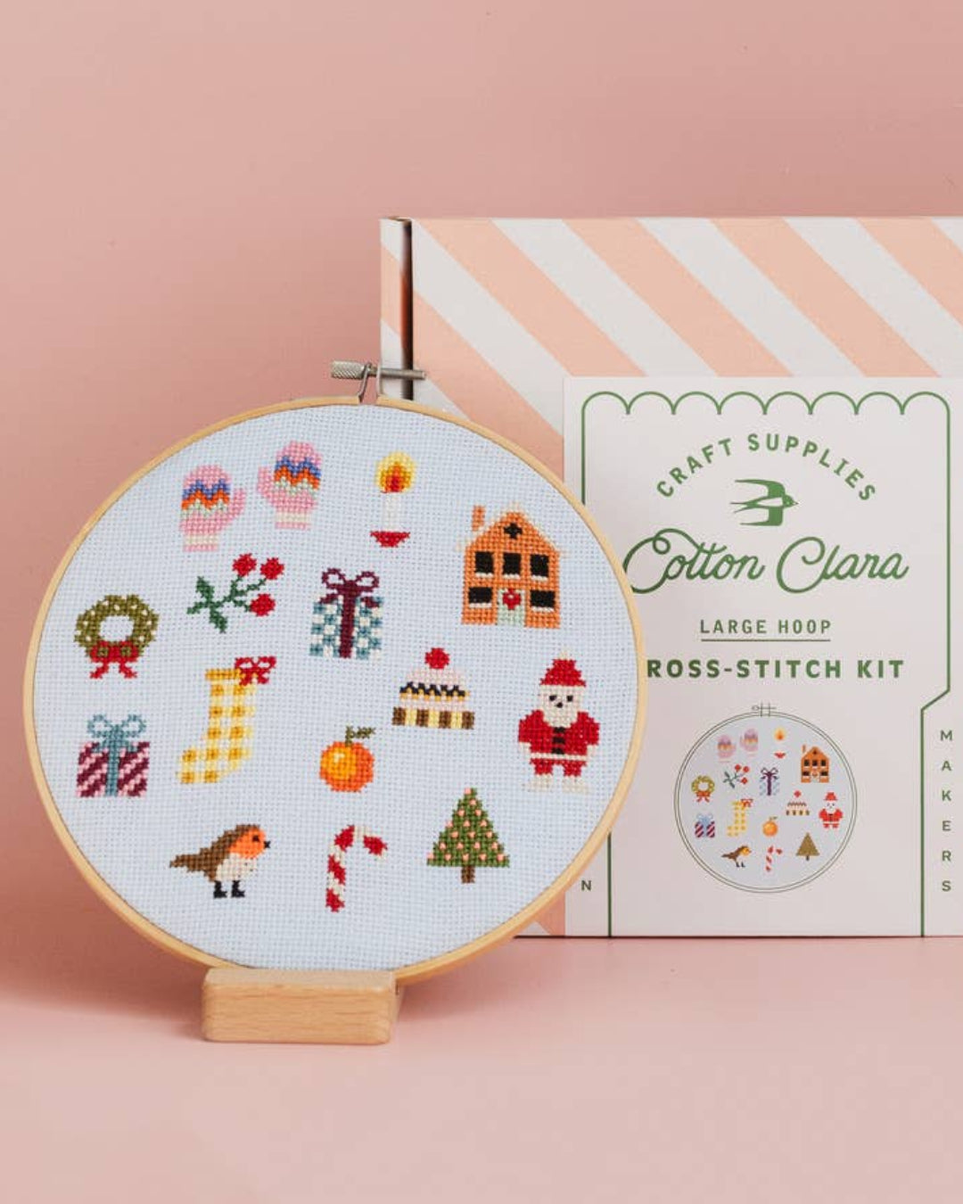 Cotton Clara Christmas-themed cross-stitch kit featuring festive colors and holiday design.