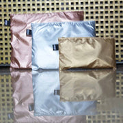 A gold, silver and rose gold set of zip pockets