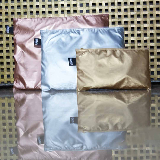 A gold, silver and rose gold set of zip pockets