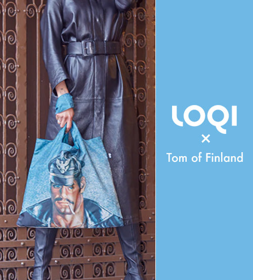 A person holding a LOQI shopping tote featuring a Tom of Finland design