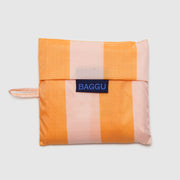 A Baggu Tangerine Wide Stripe standard reusable bag in its pouch