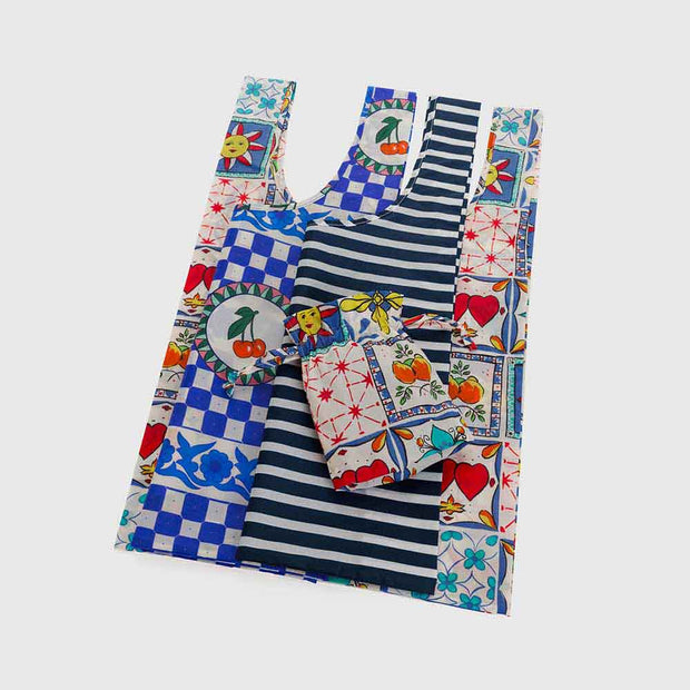 A set of 3 Standard Baggu recycled bags in the Vacation Tiles designs, including the Cherry Tile, Navy Stripe and Sunshine Tile designs laid flat