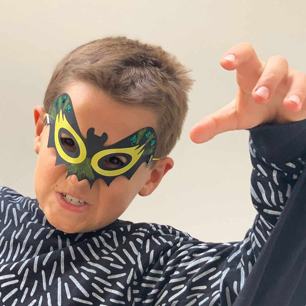 Boy wearing bat mask 